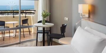 a room with a bed and table and chairs