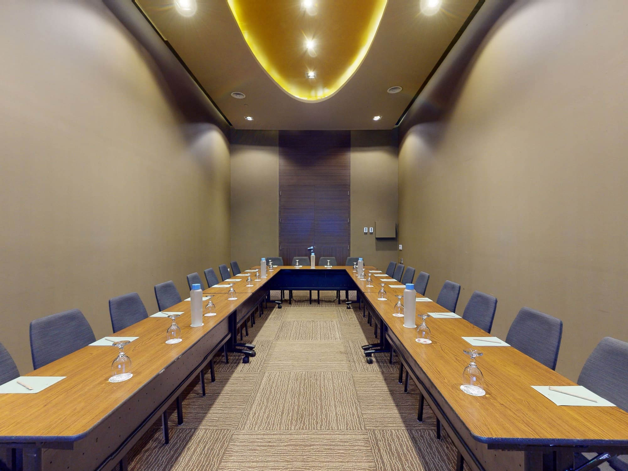 a long table with chairs and glasses on it