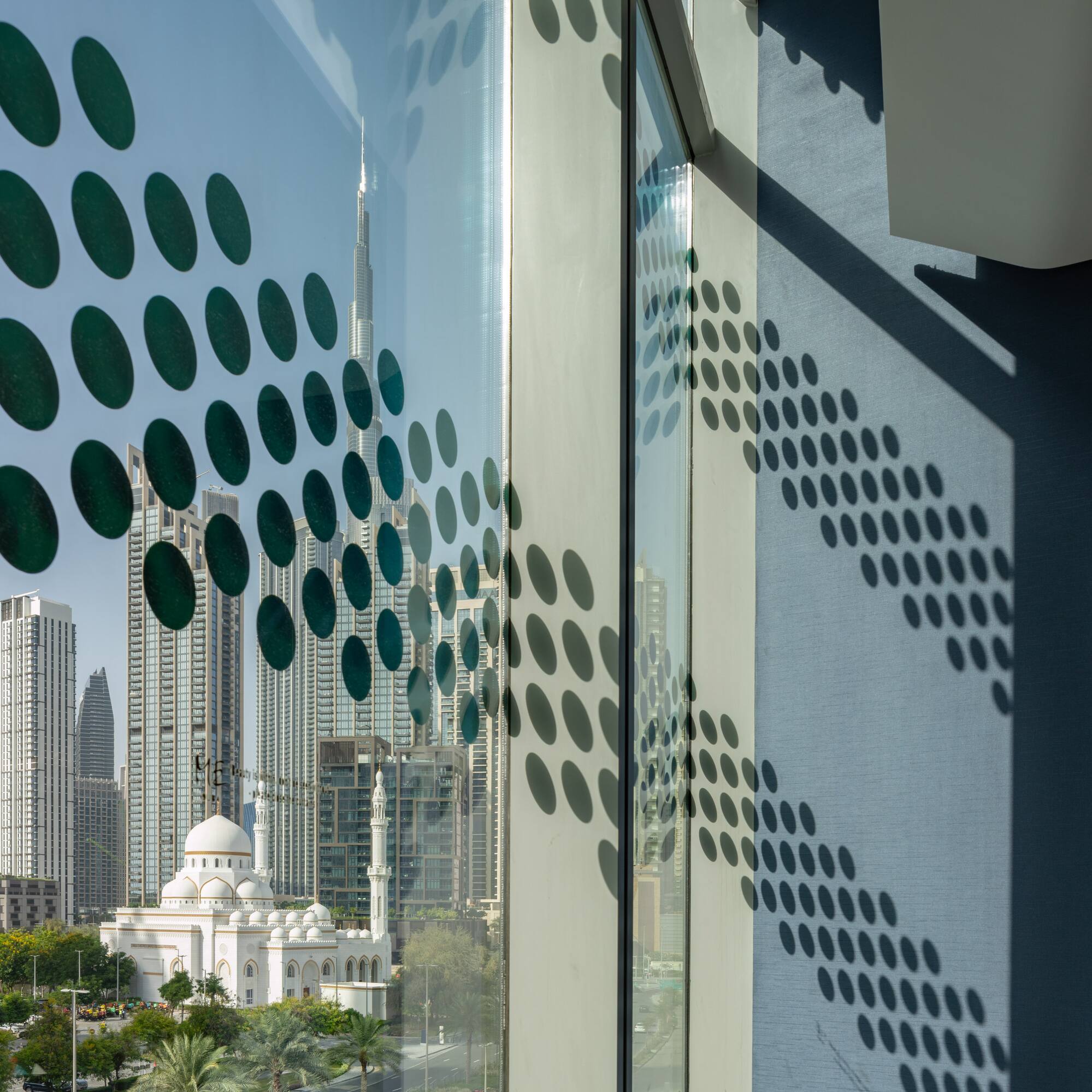 a window with a view of a city and buildings