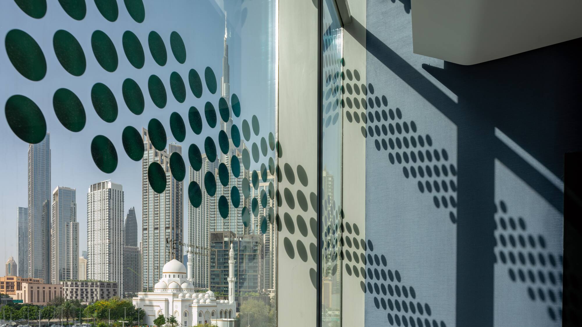 a window with a view of a city and buildings