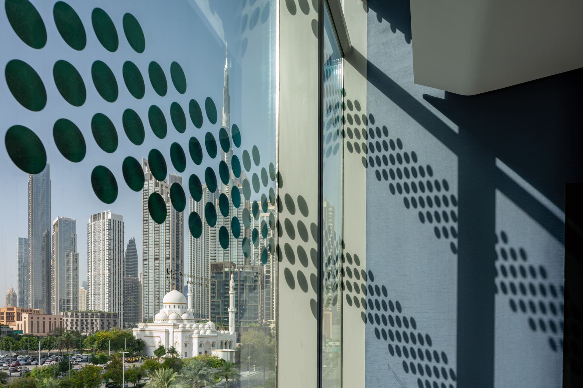 a window with a view of a city and buildings