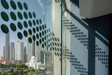 a window with a view of a city and buildings