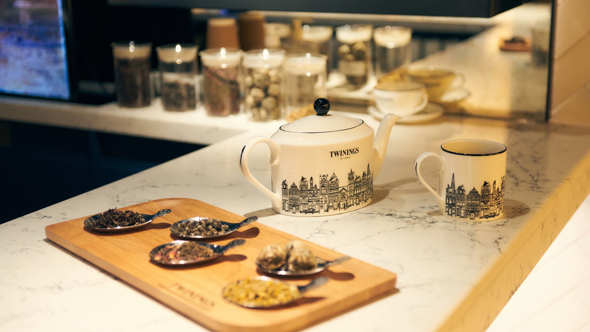 a teapot and cups on a counter