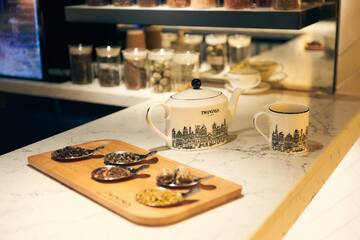 a teapot and cups on a counter