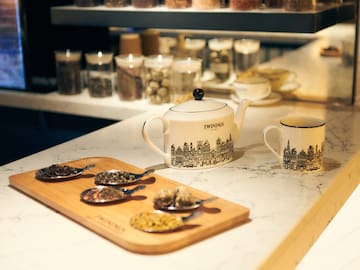 a teapot and cups on a counter