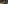 Woman in red dress in lush tropical indoor garden atrium, looking up.