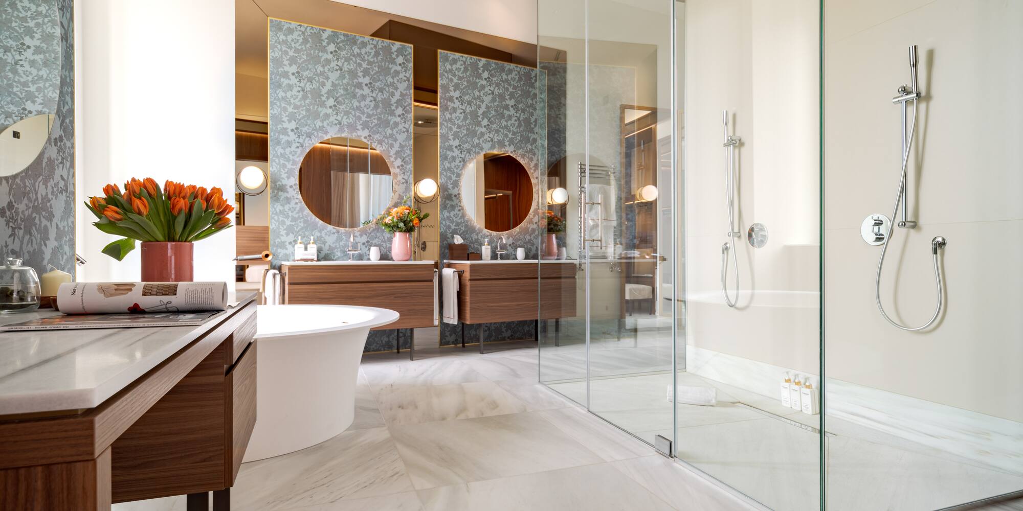 a bathroom with a glass shower and a tub