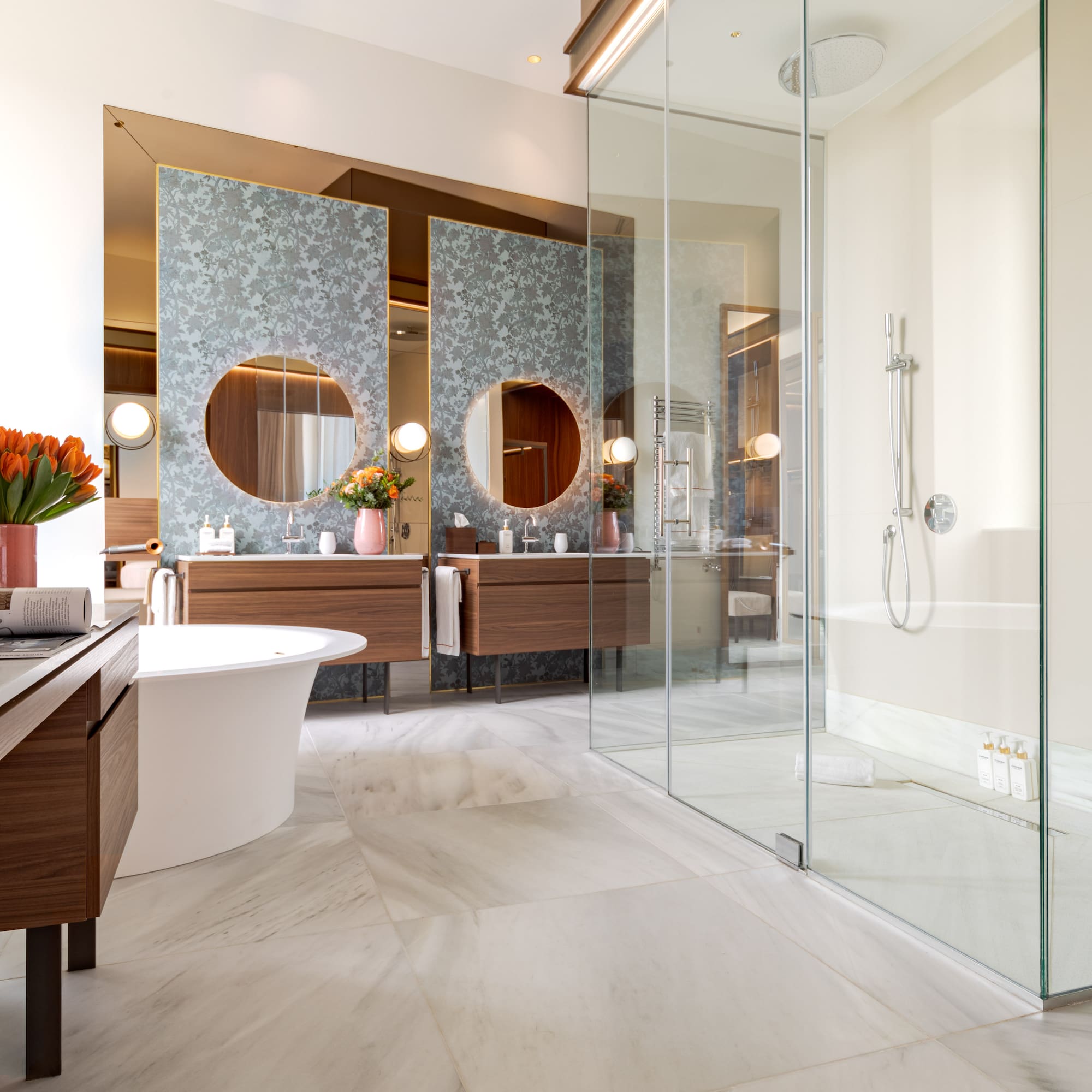 a bathroom with a glass shower and a tub