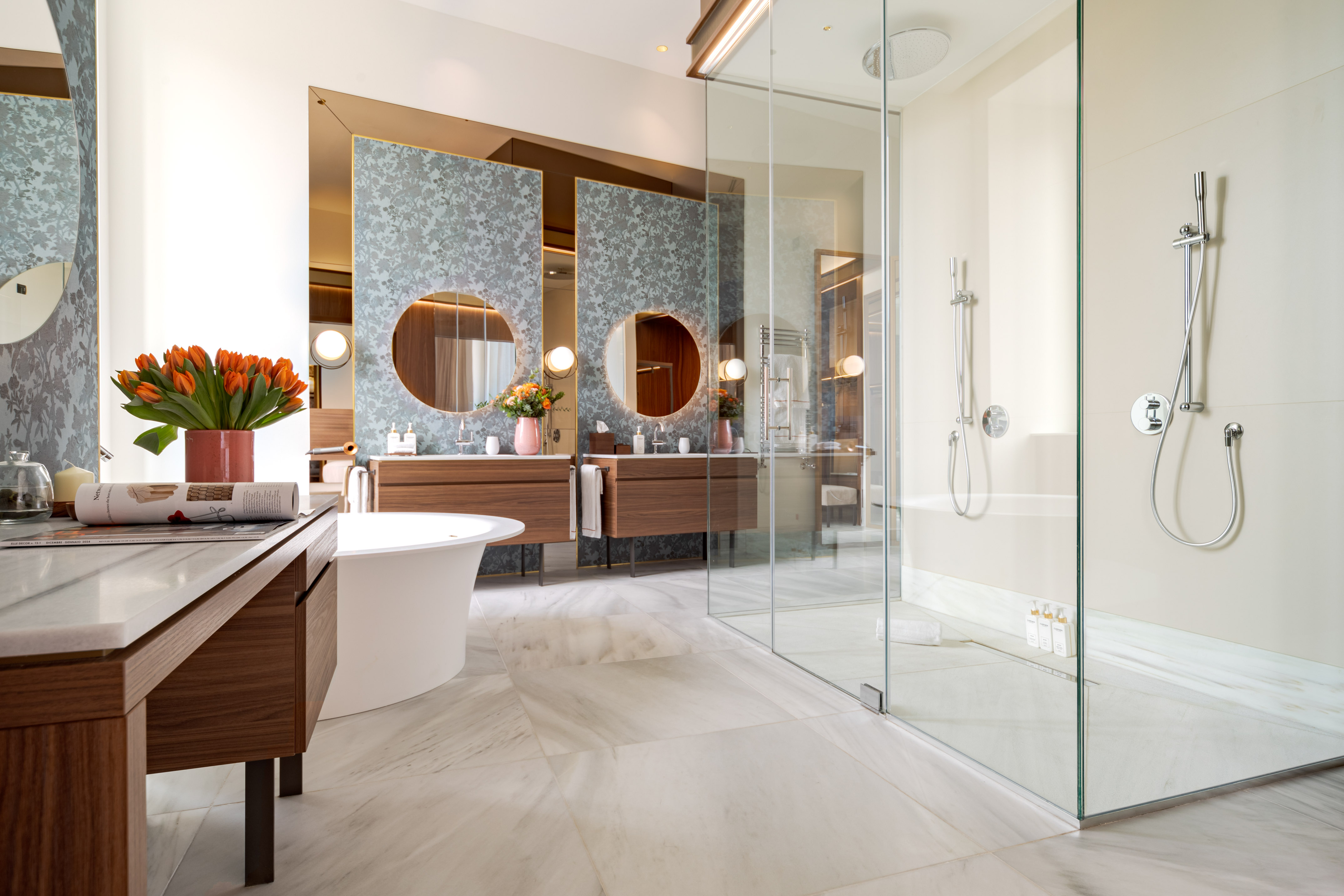 a bathroom with a glass shower and a tub