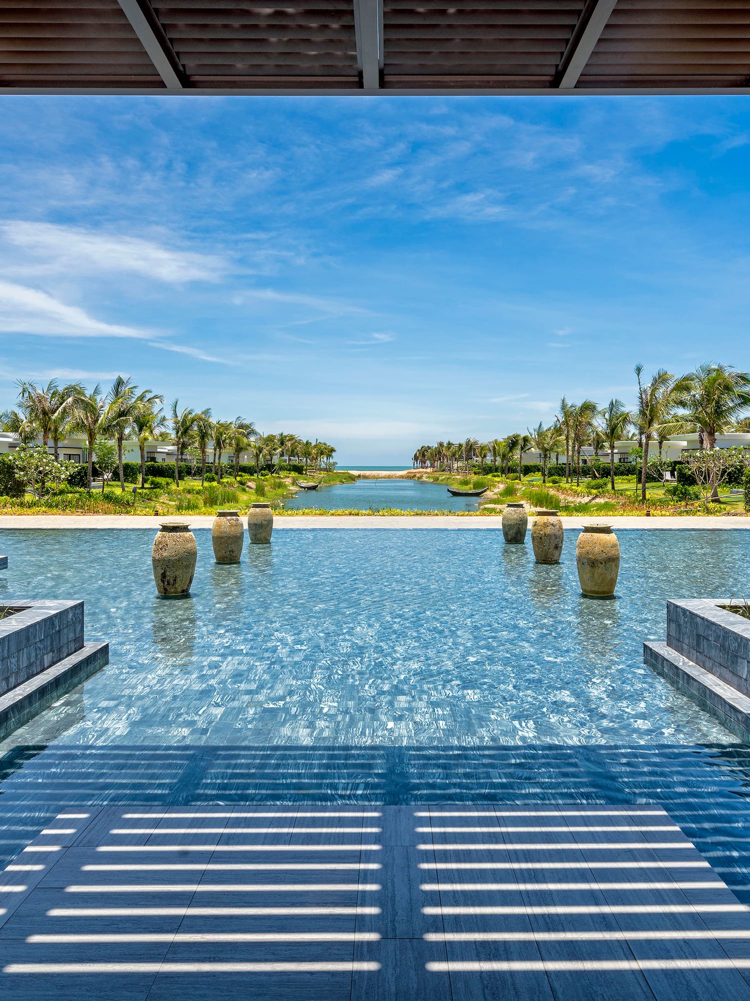 a pool with water and trees in the background