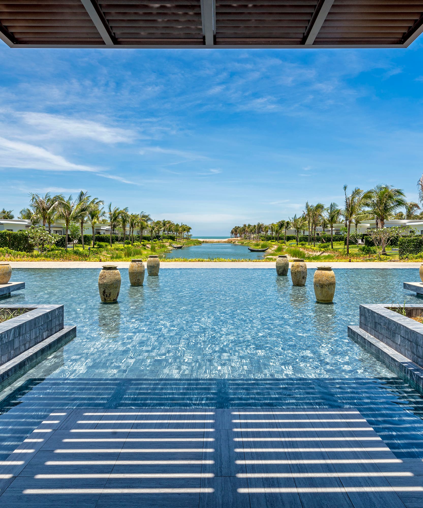 a pool with water and trees in the background