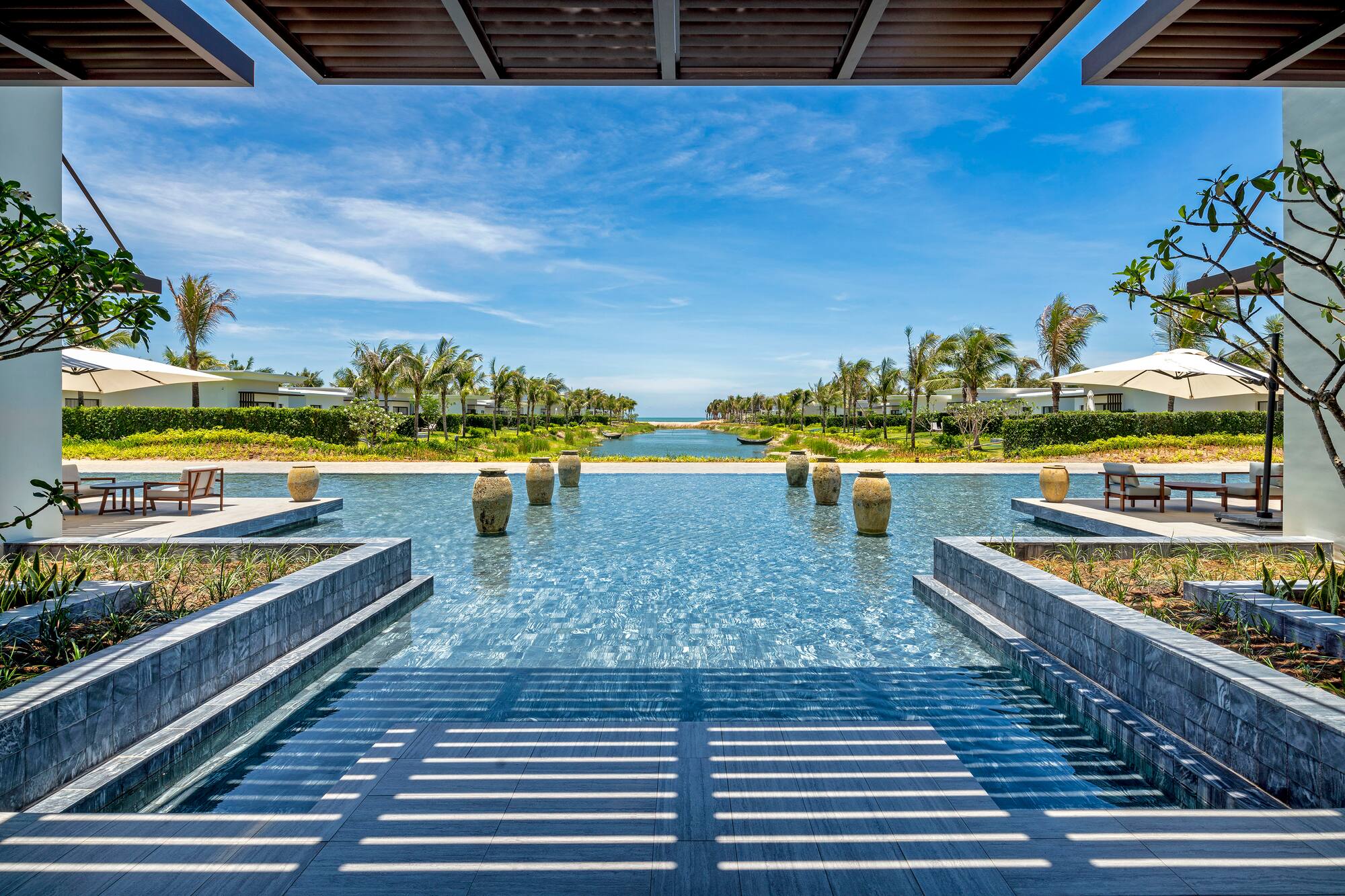 a pool with water and trees in the background