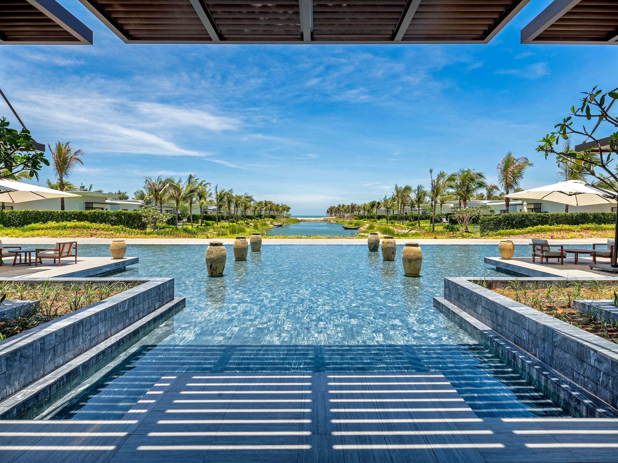 a pool with water and trees in the background