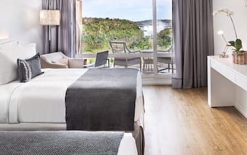 a room with a bed and a table and chairs