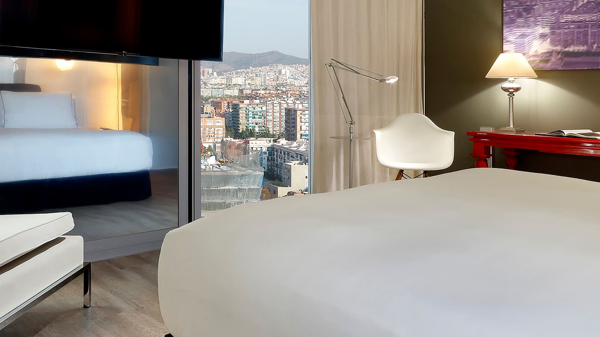 a room with a bed and a television