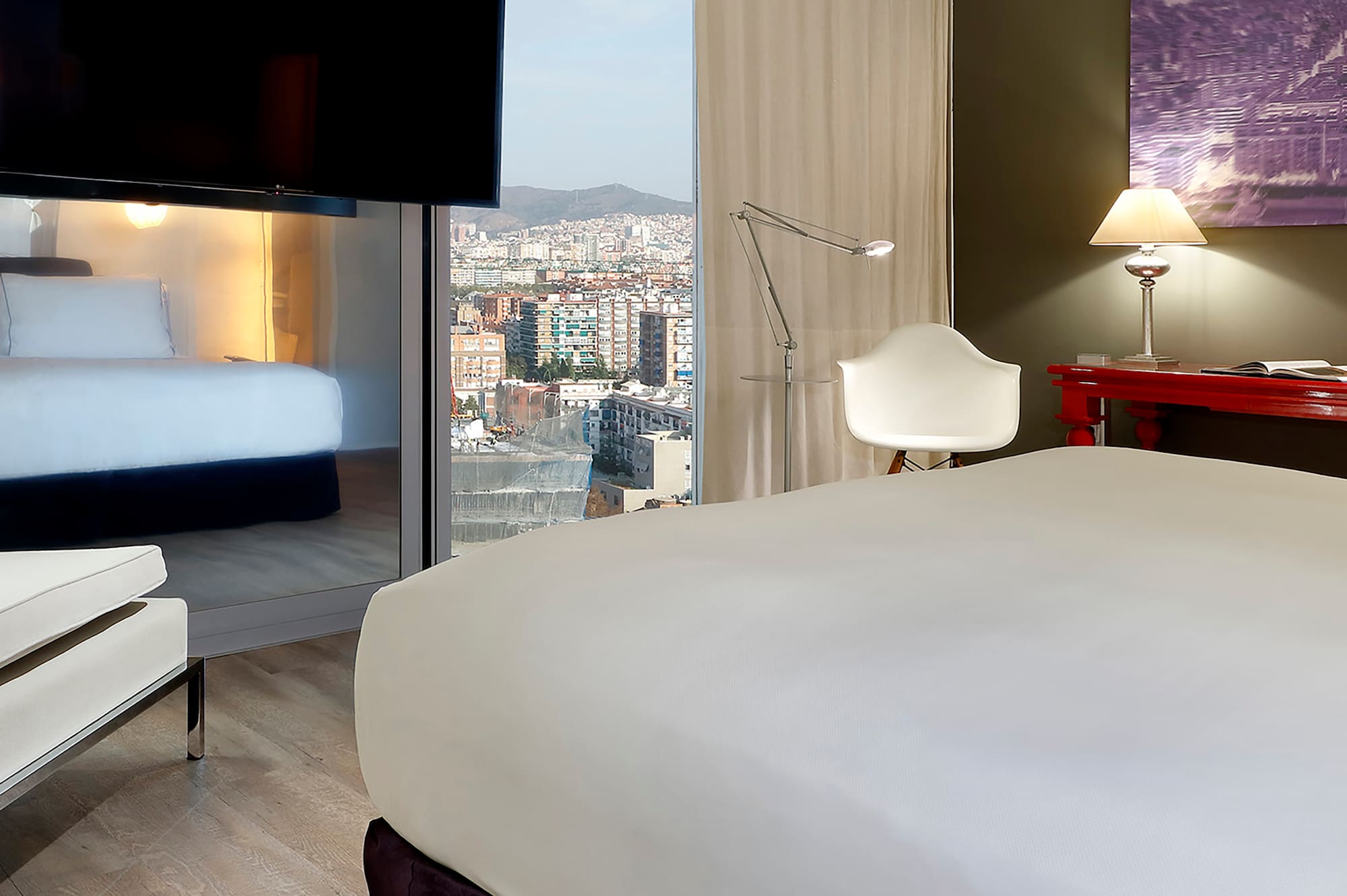 a room with a bed and a television