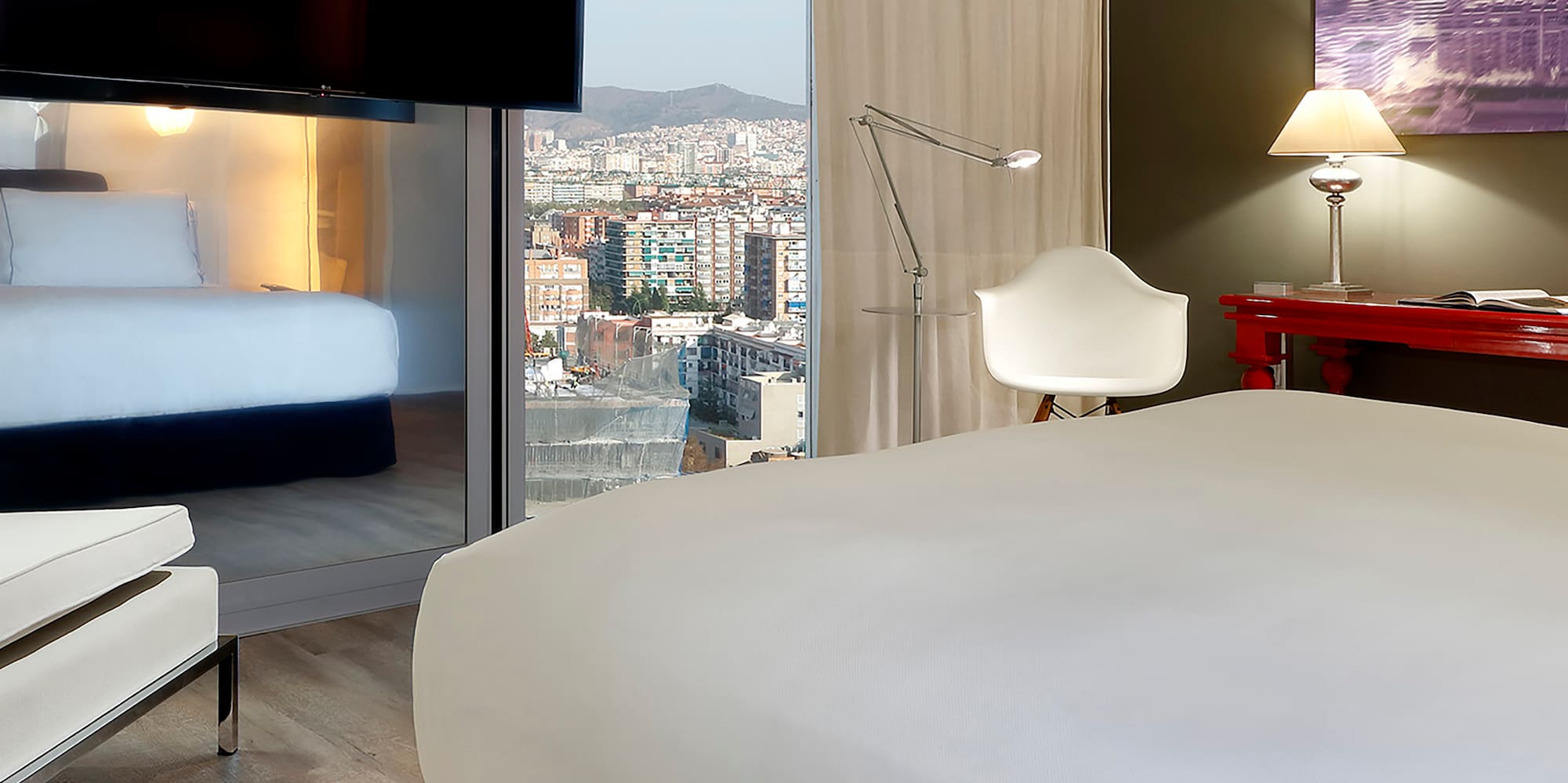 a room with a bed and a television