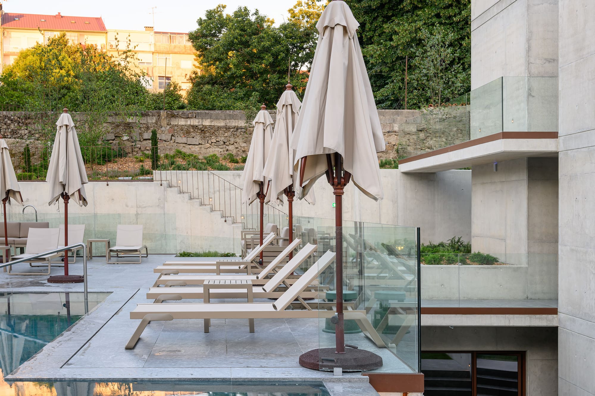 a pool with chairs and umbrellas