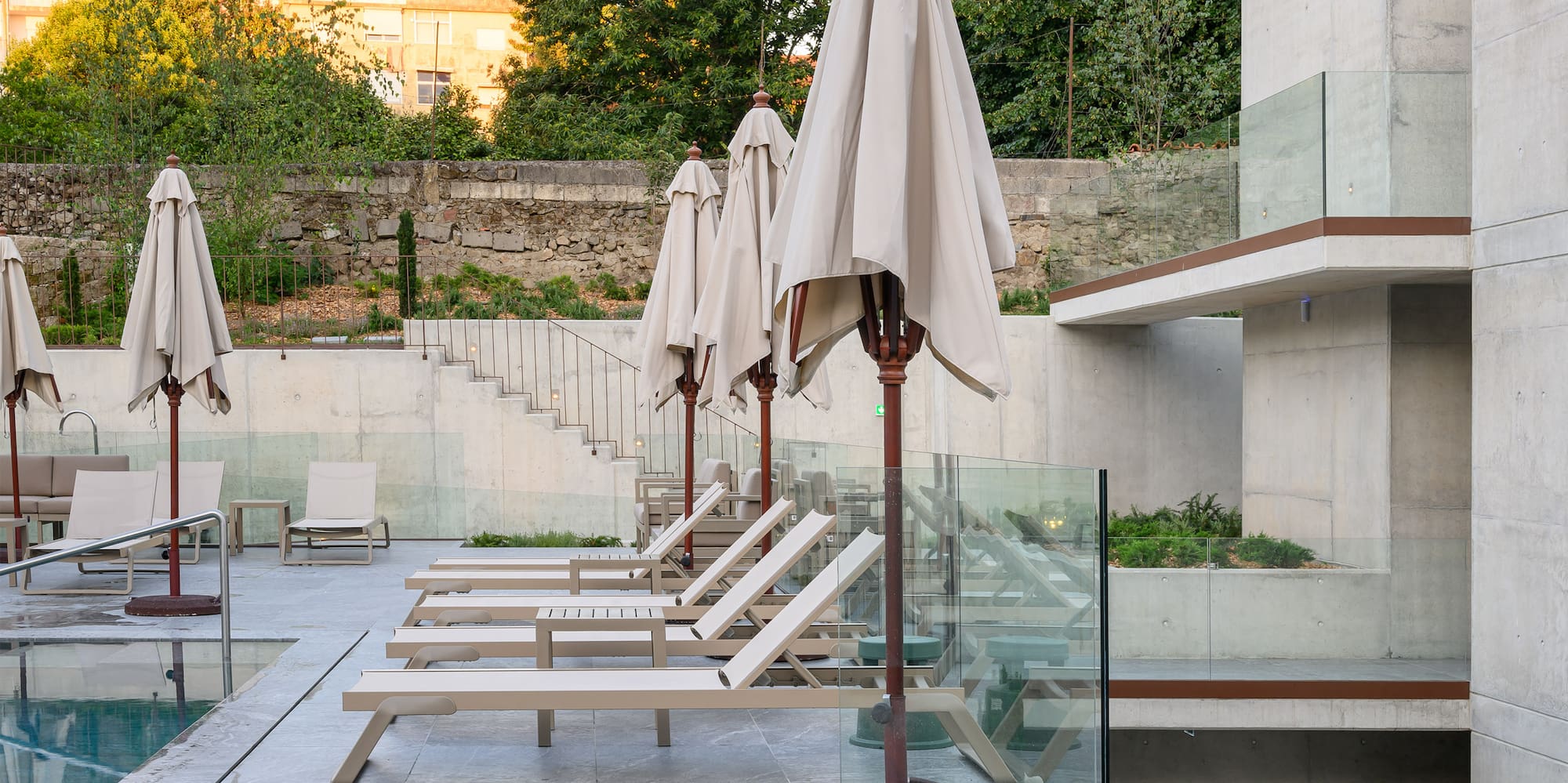 a pool with chairs and umbrellas