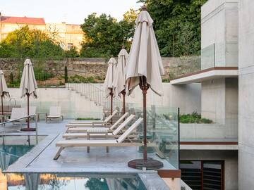 a pool with chairs and umbrellas