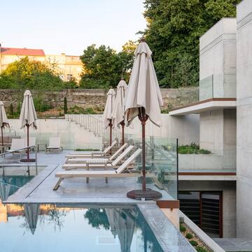 a pool with chairs and umbrellas