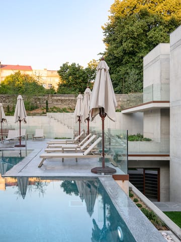 a pool with chairs and umbrellas