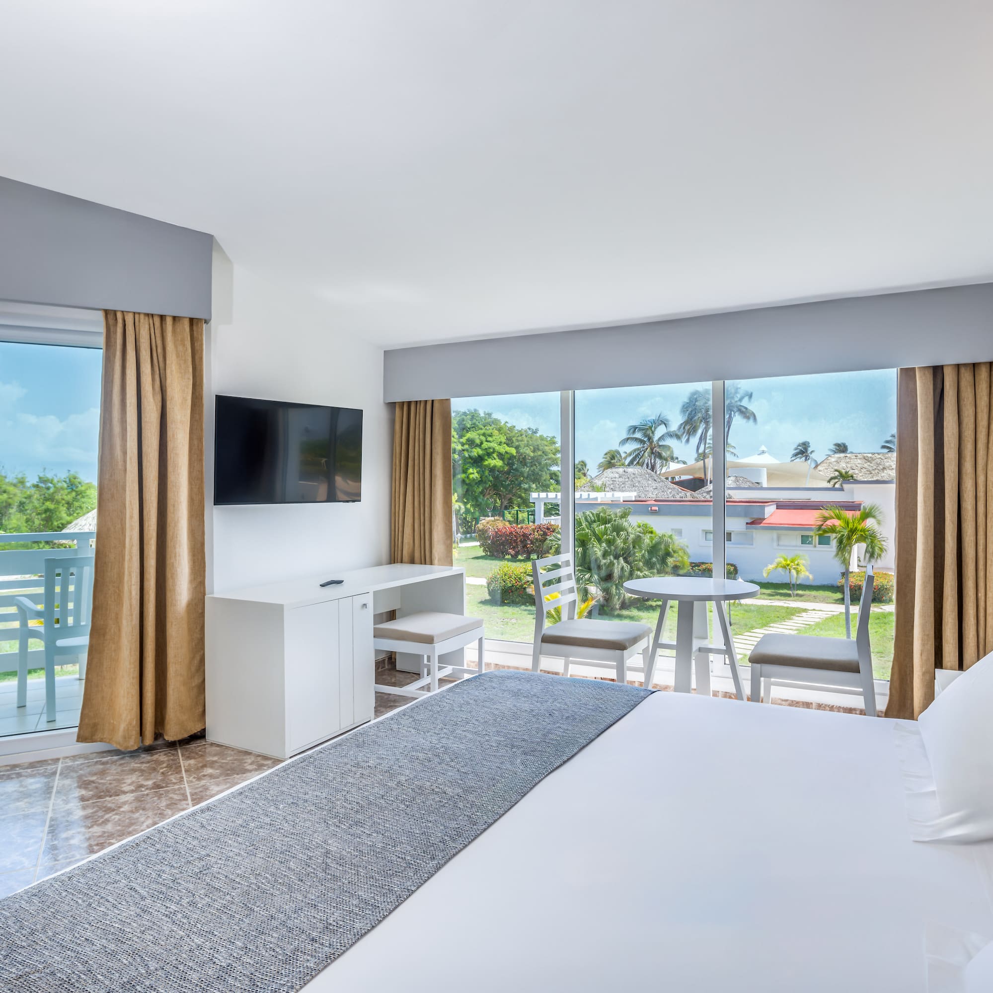 a room with a large bed and a television