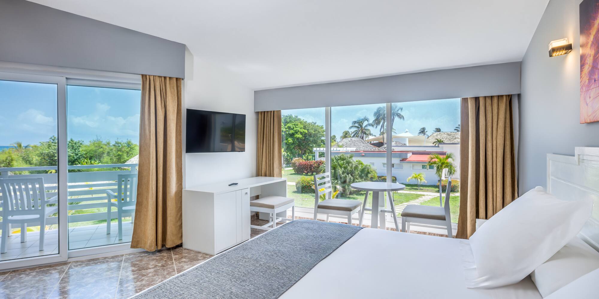 a room with a large bed and a television