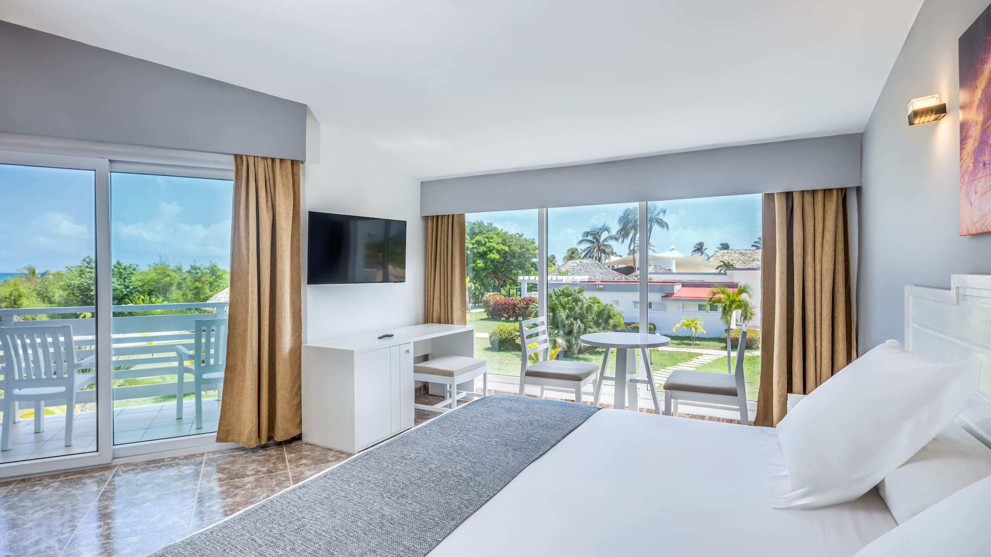 a room with a large bed and a television