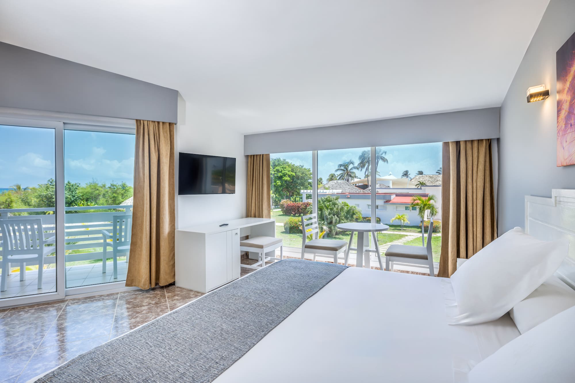 a room with a large bed and a television