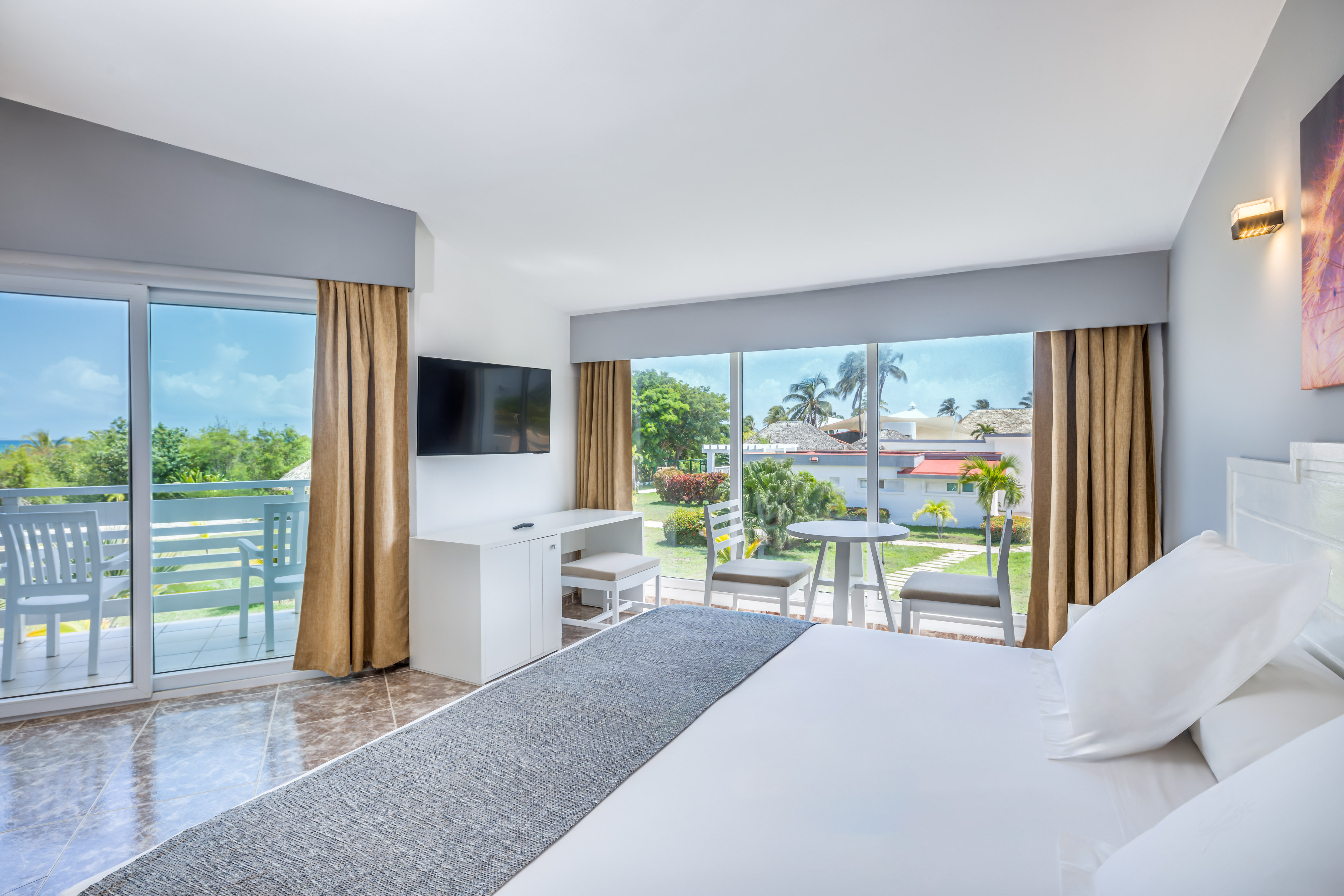 a room with a large bed and a television