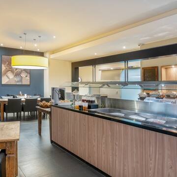 a restaurant with a buffet and a table