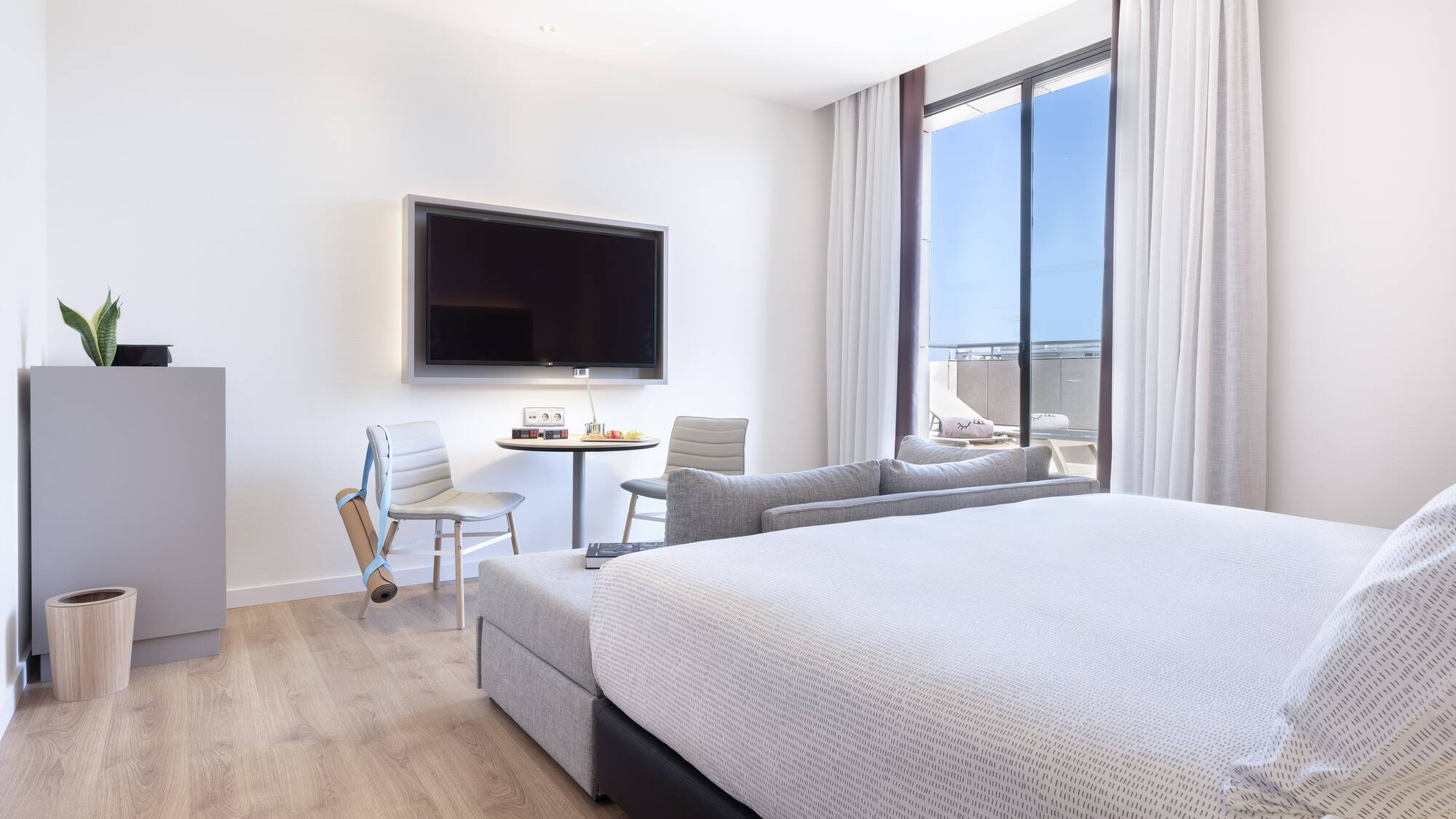 a room with a bed and a television