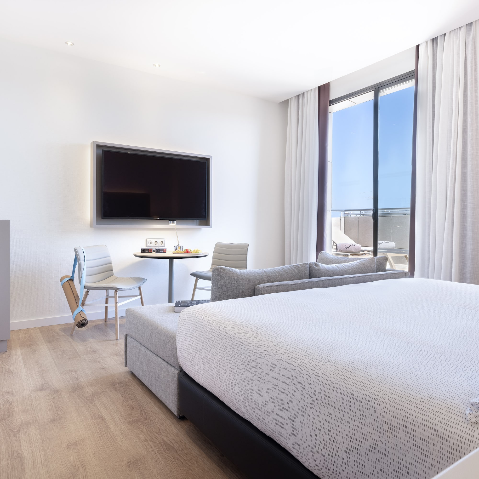 a room with a bed and a television