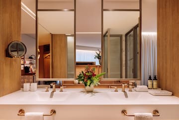 a bathroom with a plant on the counter