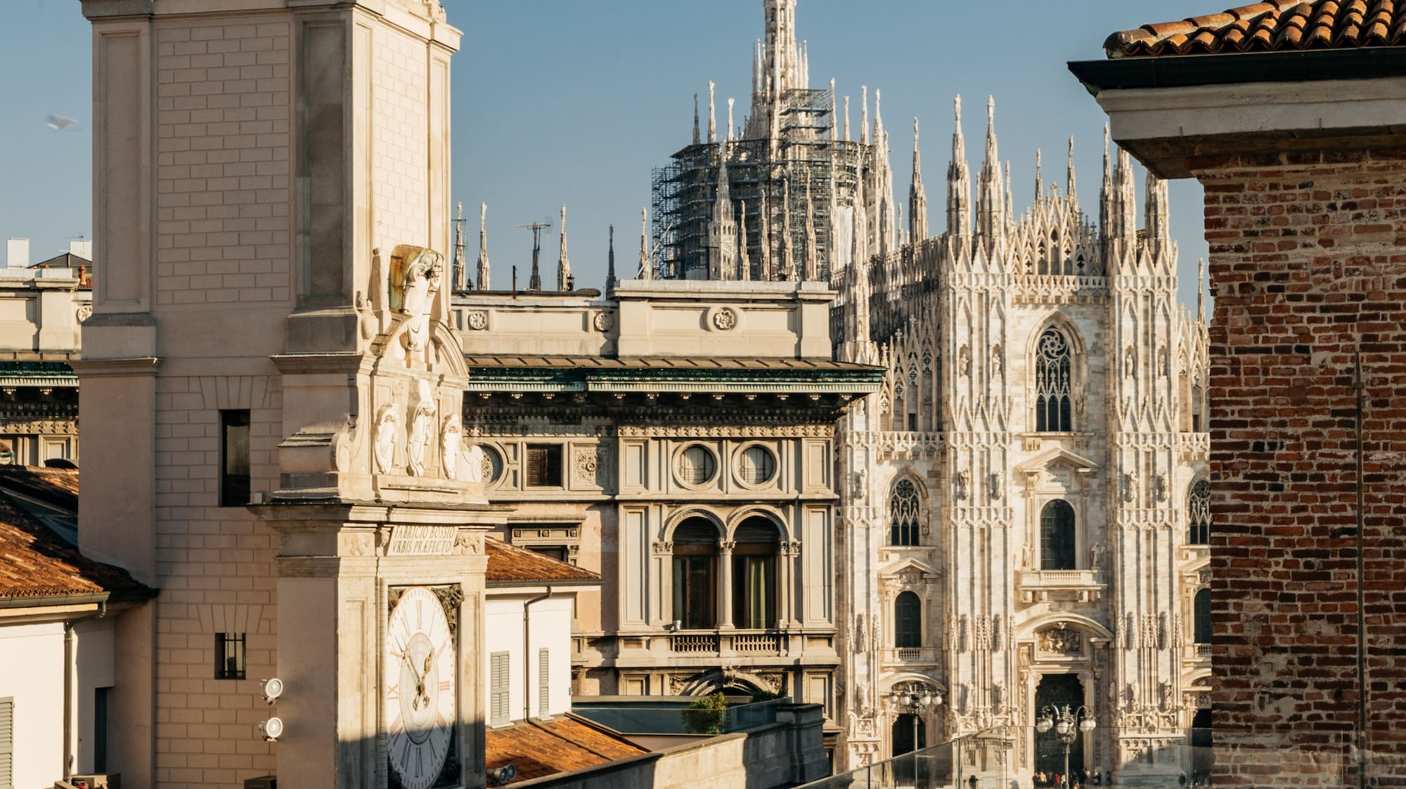 a rooftop view of a city with a clock tower and a large building