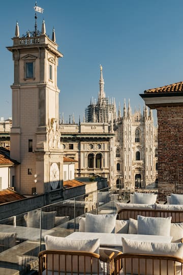 a rooftop view of a city with a clock tower and a large building