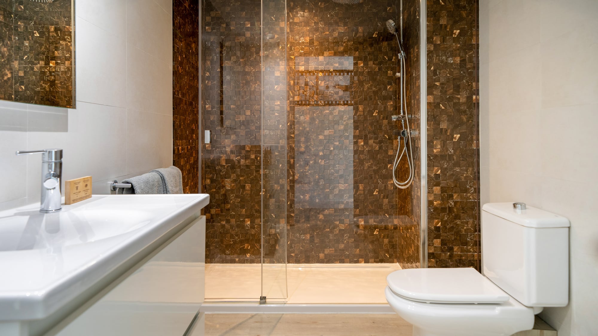 a bathroom with a glass shower door and sink