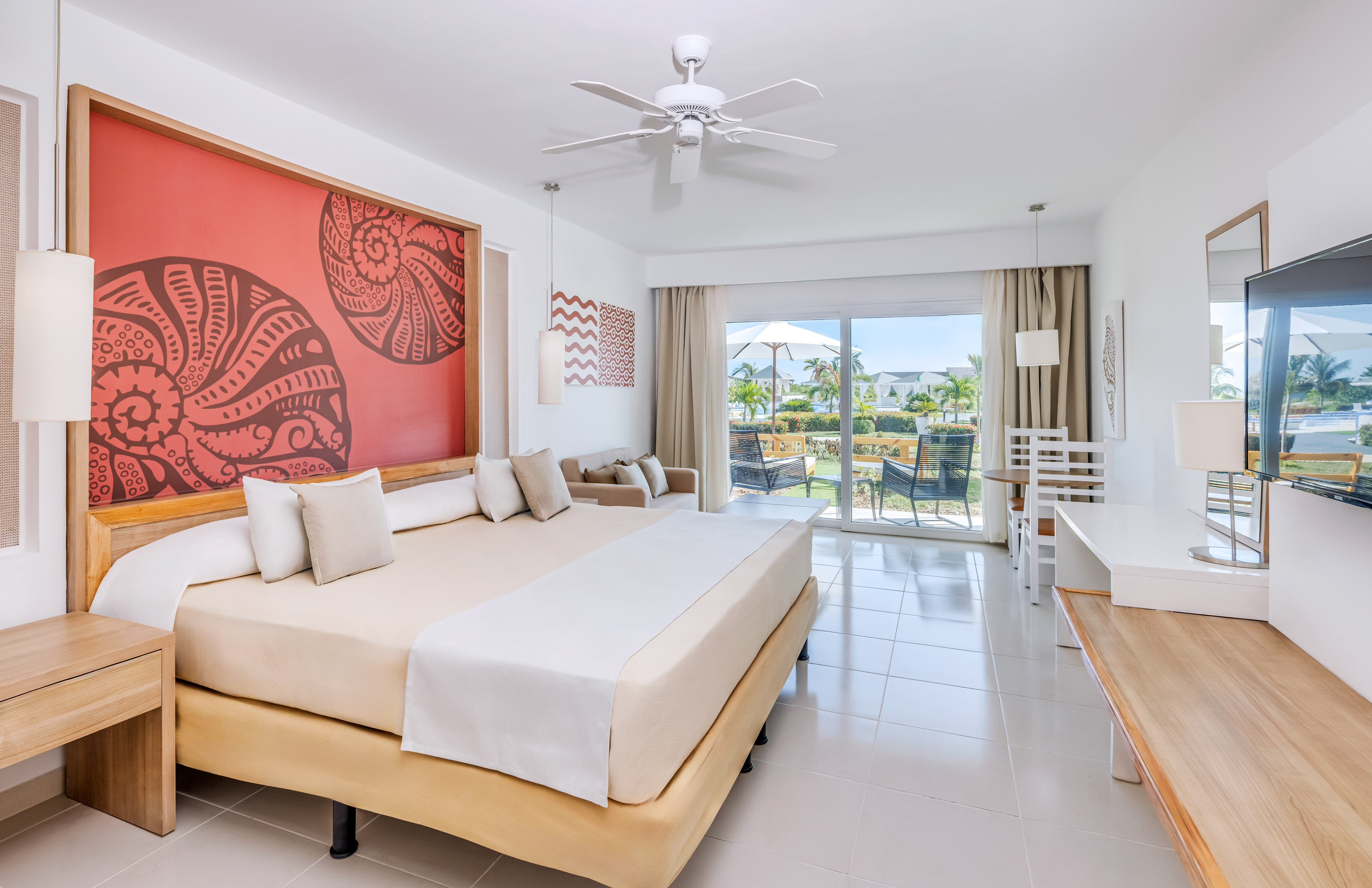 a room with a bed and a ceiling fan