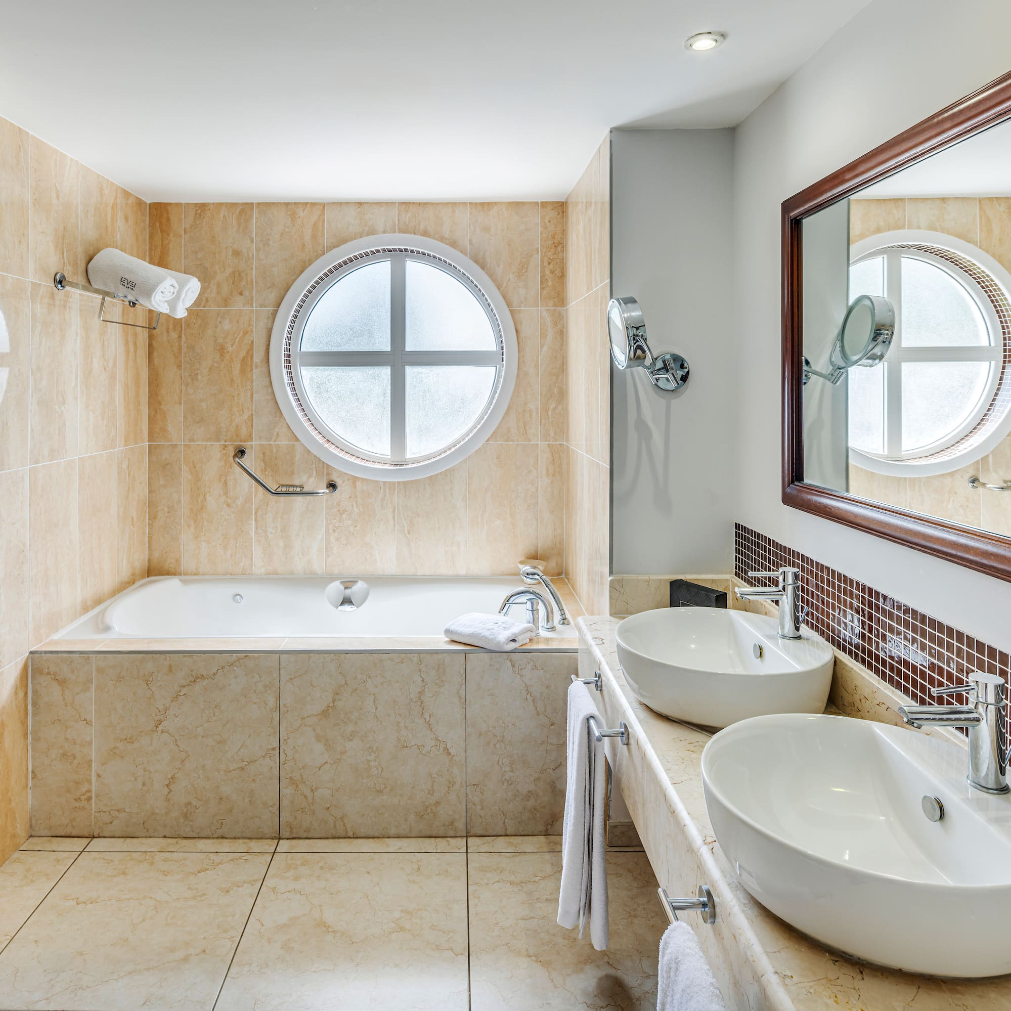 a bathroom with a tub and sinks