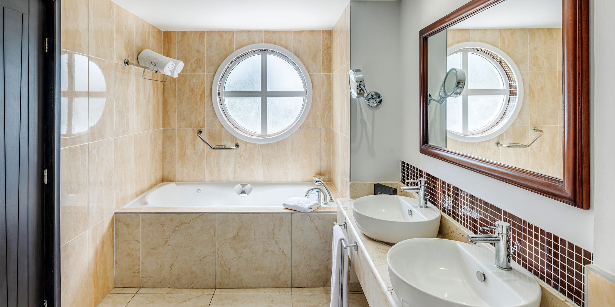 a bathroom with a tub and sinks