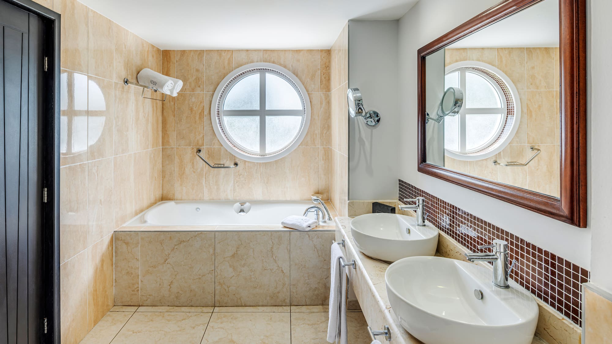 a bathroom with a tub and sinks
