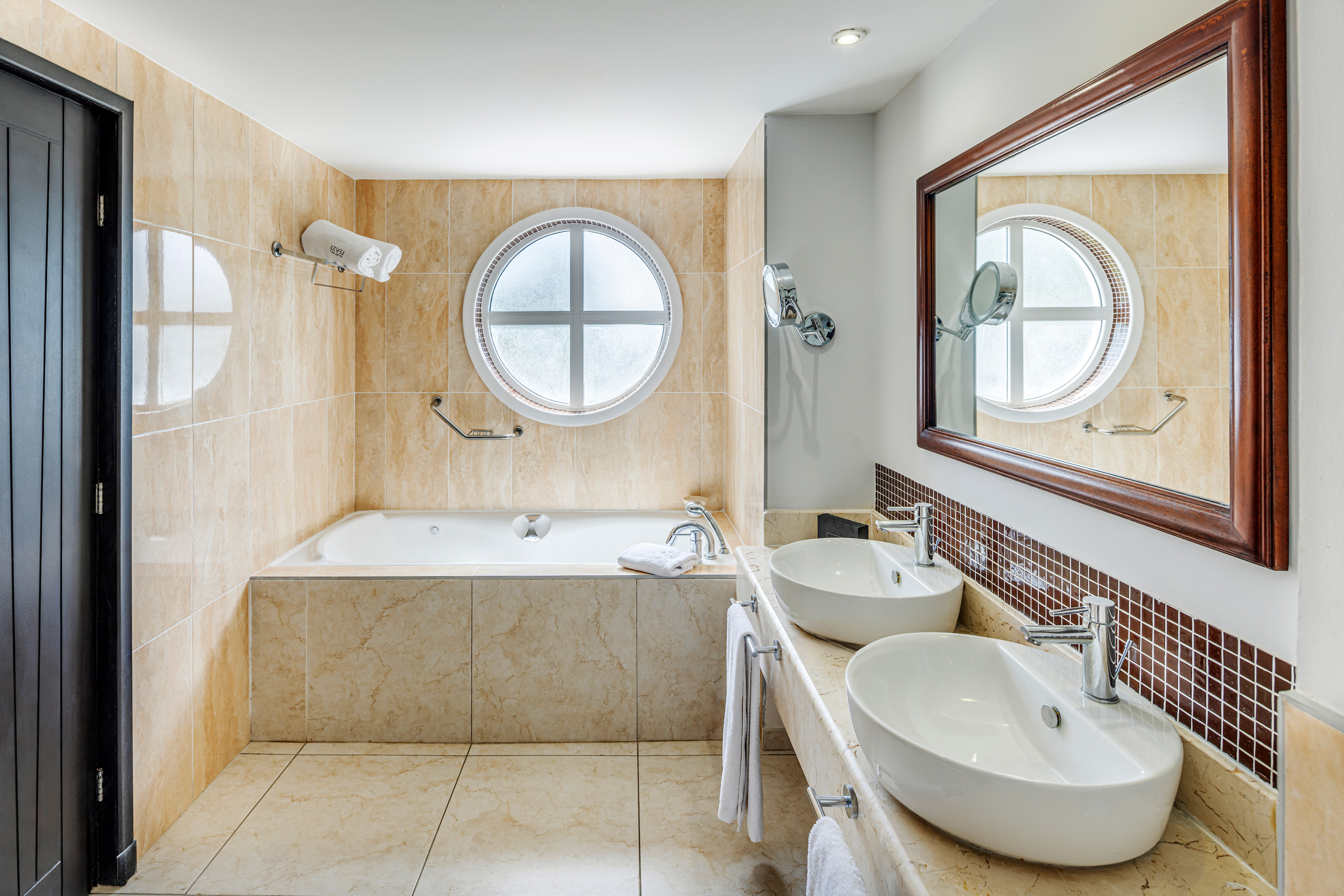 a bathroom with a tub and sinks