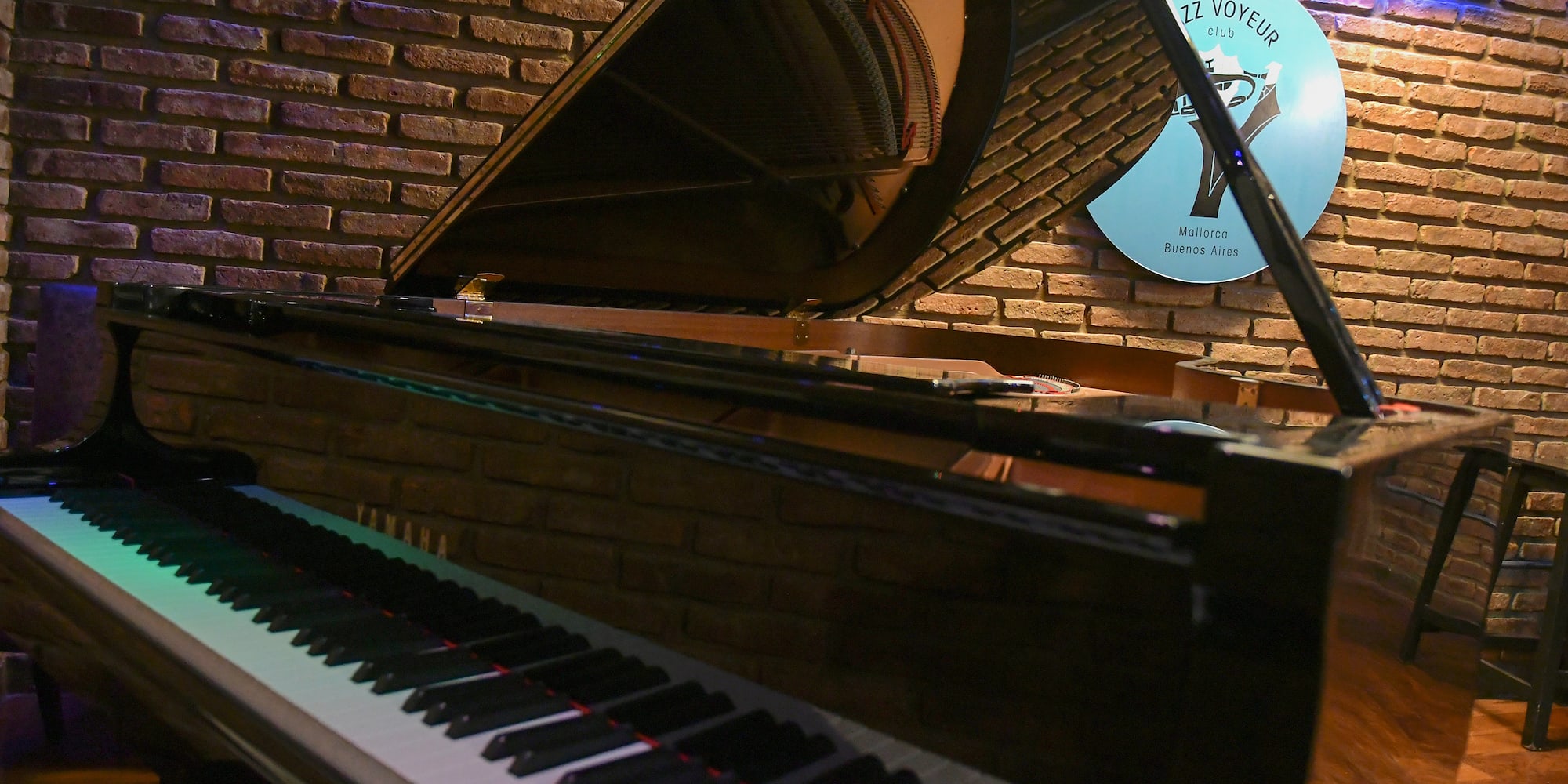 a piano in front of a brick wall