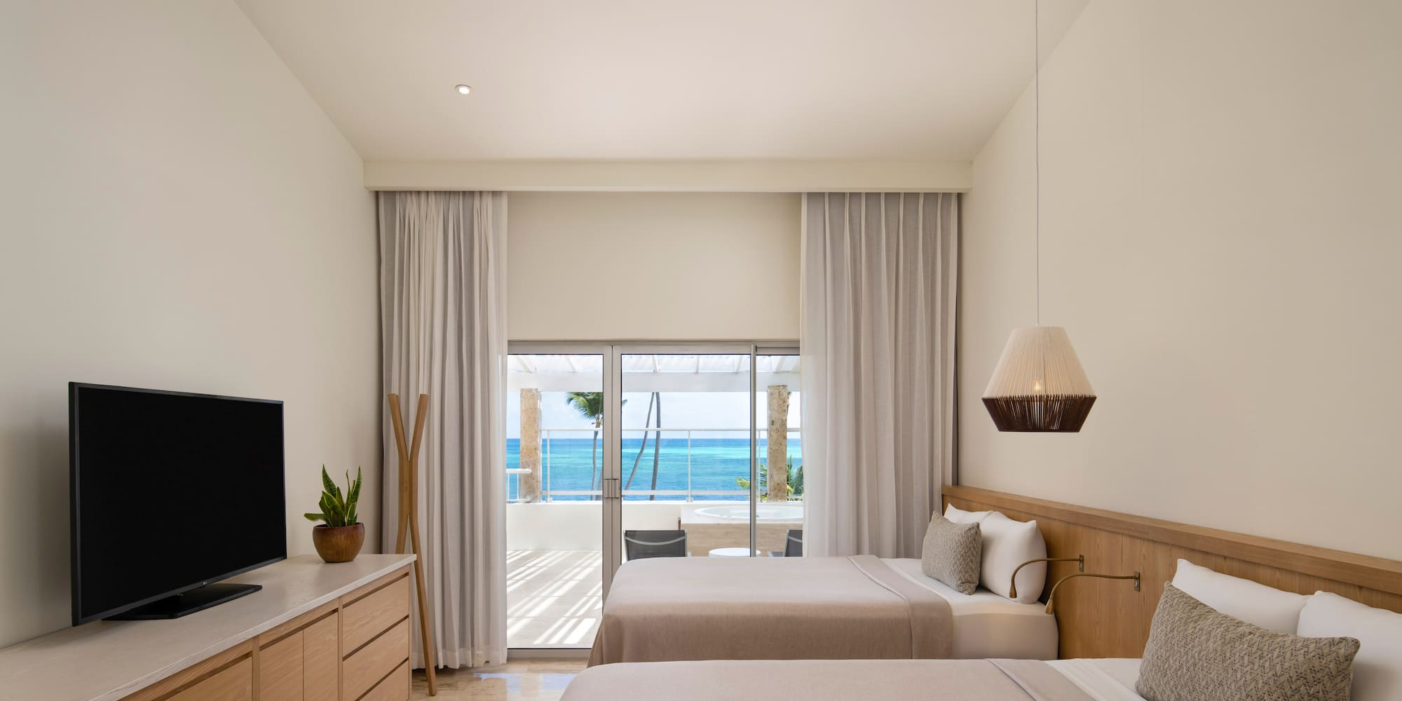 a room with two beds and a television