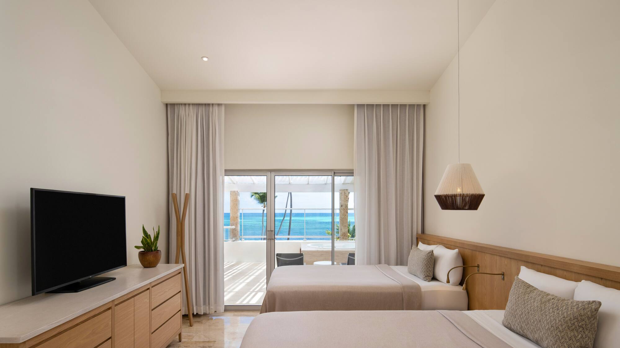 a room with two beds and a television