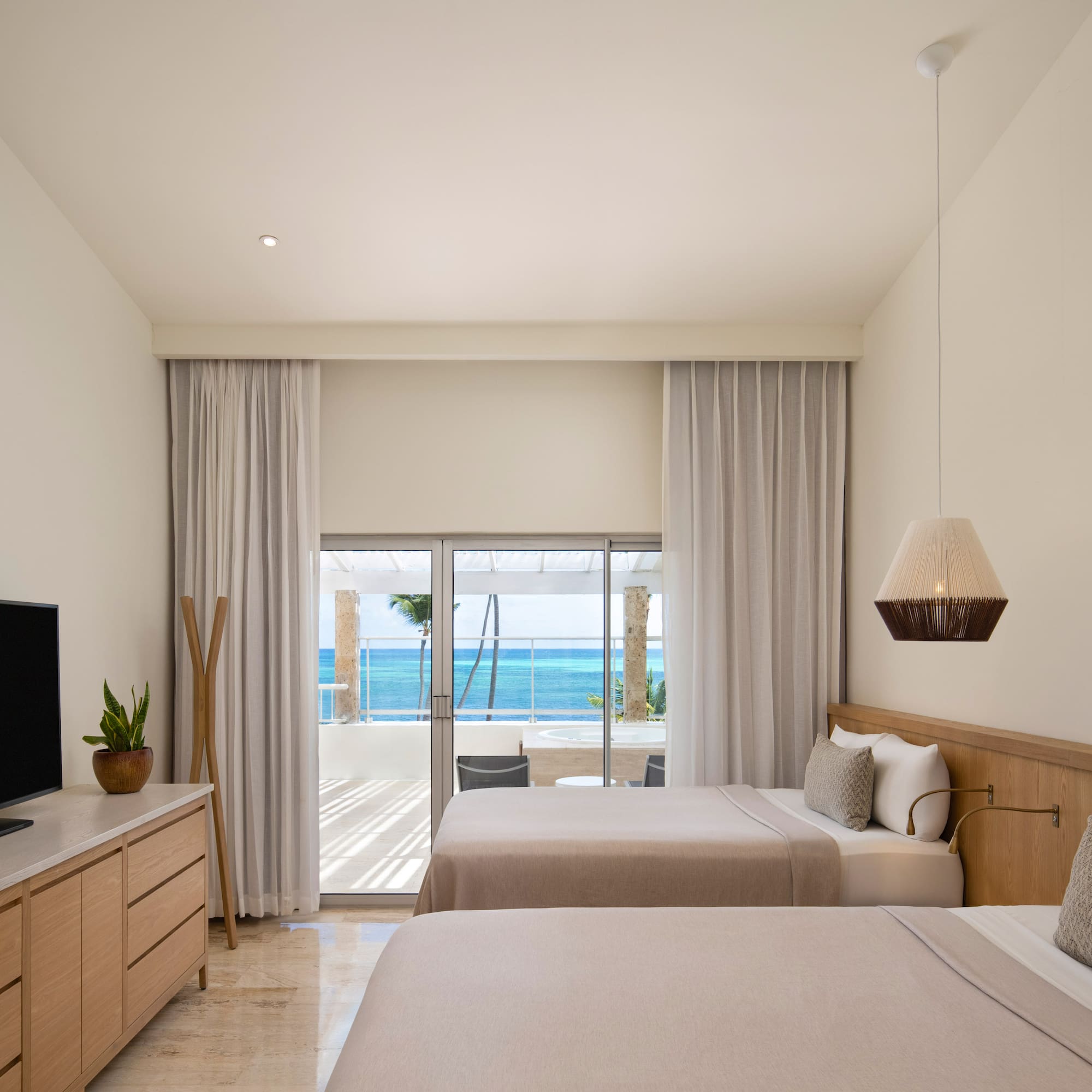 a room with two beds and a television