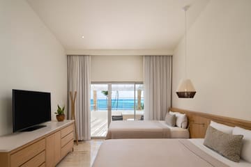 a room with two beds and a television