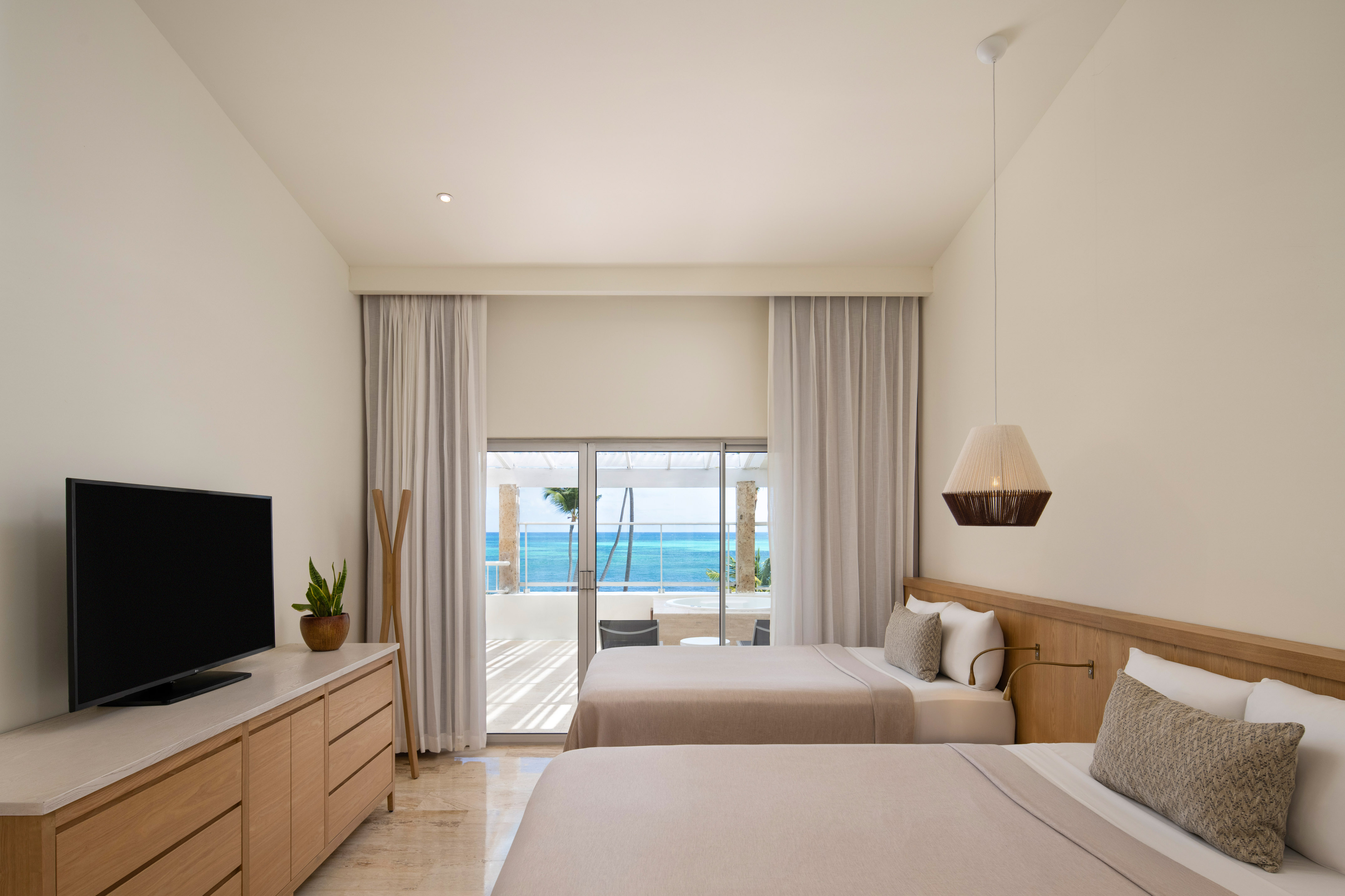 a room with two beds and a television