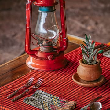 a table with a red lantern and a potted plant